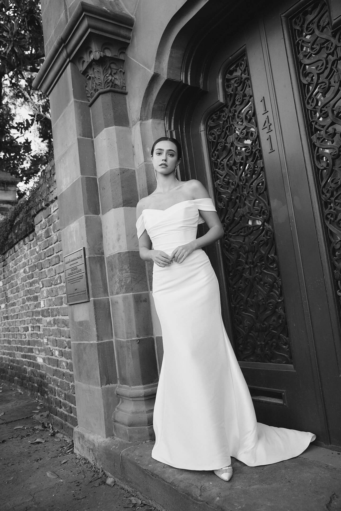 A woman in an elegant off-shoulder wedding gown outside the Georgetown boutique